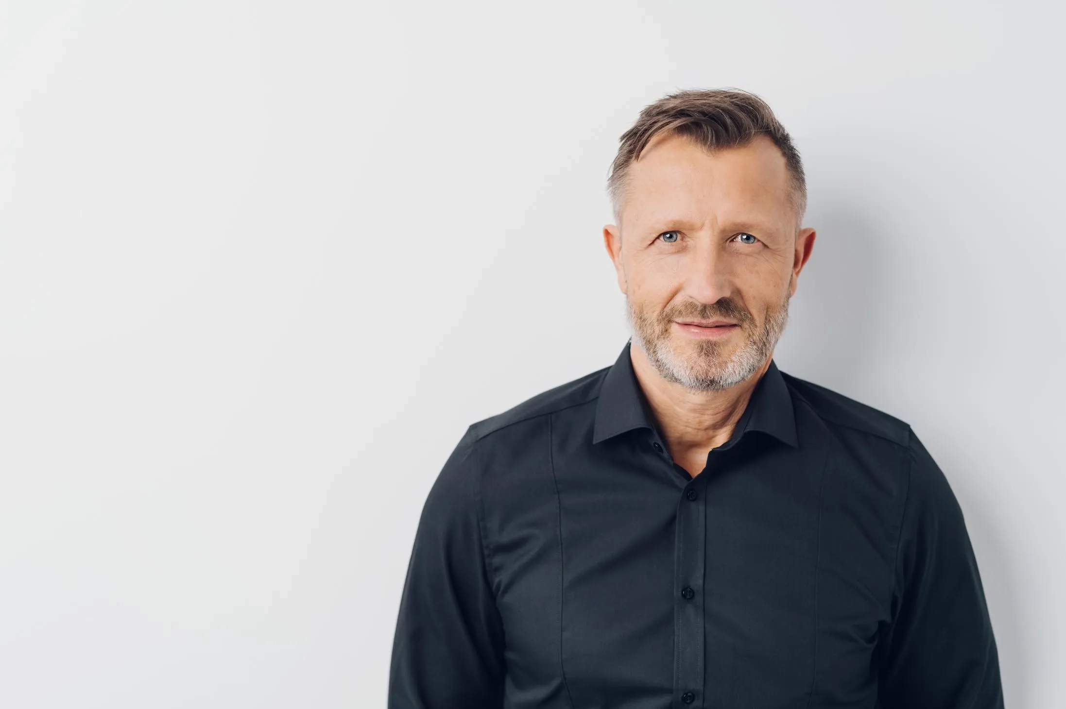 Man standing against a gray background